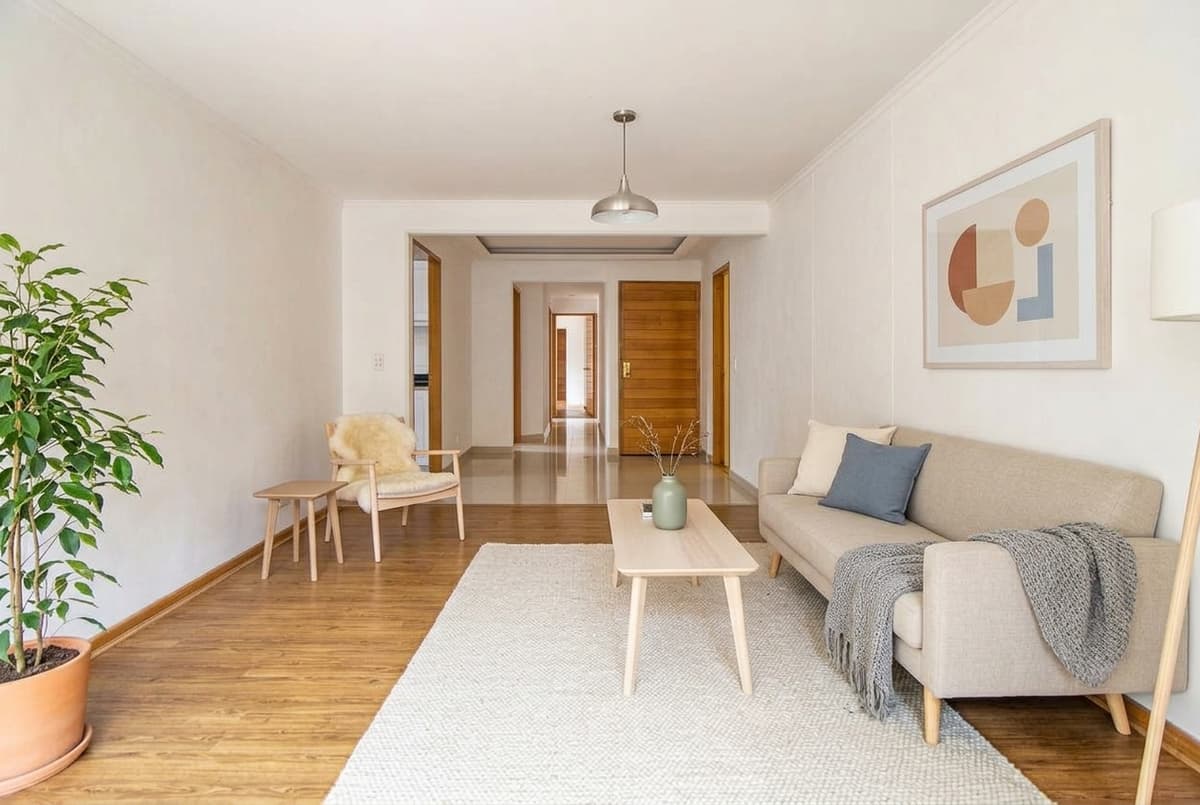 After: Virtual staging before and after — empty living room staged in Scandinavian style with sofa and rug