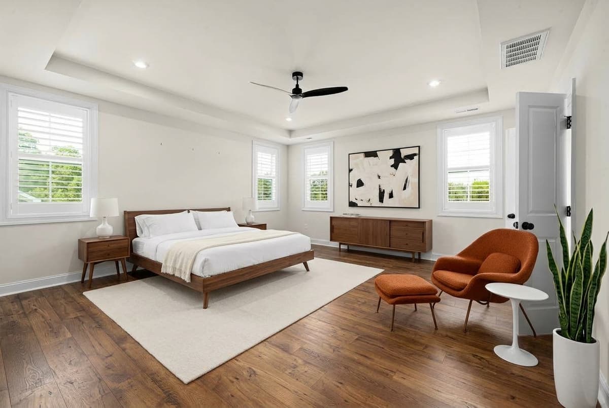 After: Virtual staging for real estate — empty bedroom staged in mid-century modern style with walnut bed frame
