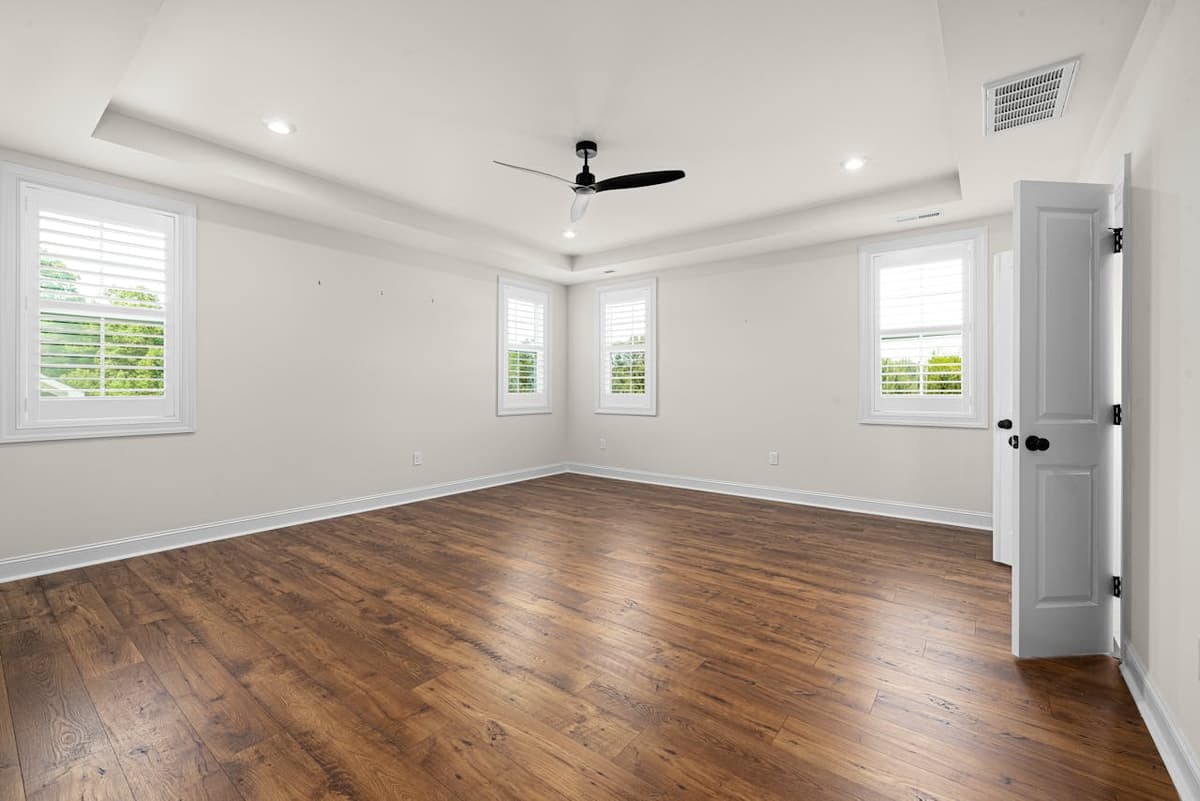 Before: Virtual staging for real estate — empty bedroom staged in mid-century modern style with walnut bed frame